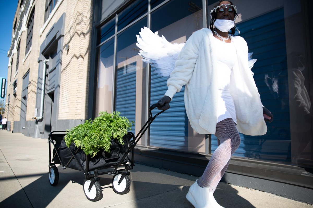  A volunteer with The Fruit Fairy Foundation carries a wagon of fresh produce to early voters in Cuyahoga County on October 31, 2020.